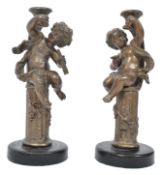 A pair of 19th century cold painted bronzed spelter candlesticks of neo-classical form being