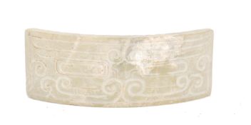 A Chinese curved jade plaque, translucent and calcified. The plaque with conjoined cloud motif's,