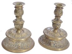 A pair of 19th century Victorian bras candlesticks raised on a two tier tapering circular base