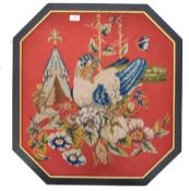 A 19th / 20th century needlework panel of vibrant colour and form. The octagonal panel on red ground