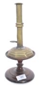 An 18th / 19th century English Hogscraper candlestick having a seamed brass wedding band stem with