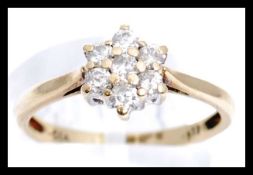 A hallmarked 9ct gold and diamond cluster ring. Ha