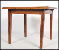 A 1930's oak draw leaf dining table being raised o