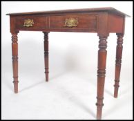 A Victorian mahogany writing table desk being rais