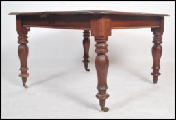 A Victorian mahogany wind out / pull out dining ta