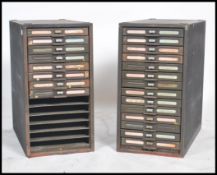 A pair of black metal filing index cabinets with 1