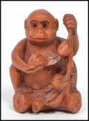 An Oriental Chinese carved wooden netsuke in the f