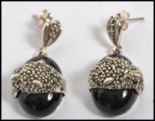 A pair of contemporary silver and marcasite onyx e