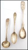 A group of three silver metal spoons, two hallmarked spoons to include a teaspoon with London