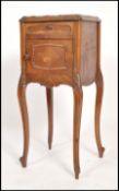A 19th century French marble bedside cabinet having sabre legs with a cupboard under short drawer