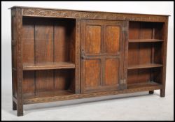 A late 19th /  early 20th century oak Jacobean revival open window large bookcase cabinet being