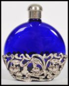A silver and blue glass ladies perfume bottle flask. Of moon shaped form with pierced silver