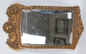 A 19th century Victorian mirror having an inset bevelled glass panel with a carved and moulded