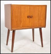 A vintage 20th century  retro teak wood media cabinet raised on sputnik legs with vinyl record