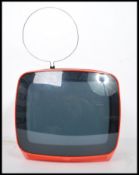 A vintage retro 1970s Indeset portable television finished in a vibrant orange complete with the