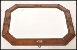 A 1920's oak framed Jacobean revival overmantel mirror with embellished frame having central