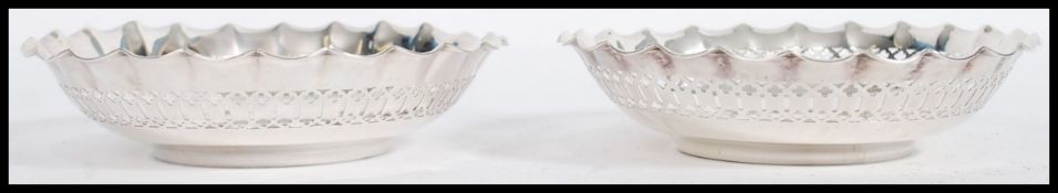 A pair of sterling silver hallmarked bon bon dishes having fret pierced surrounds. Hallmarks for
