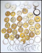 A good collection of vintage 19th and 20th century pocket watch movements, faces and dust covers,