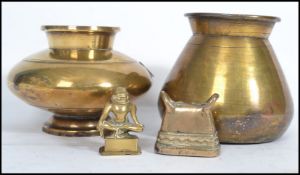 Two 18th century brass vases of baluster form along with a brass Chinese bell and figurine of a
