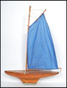 A vintage mid 20th century pond yacht having painted and varnished wood construction with brass