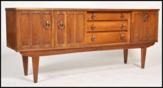A 1970's retro teak wood sideboard being of Danish influence. Raised on tapering legs with a