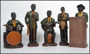 A mid 20th century 1950s five piece ceramic figures jazz band figurine group consisting of Piano,