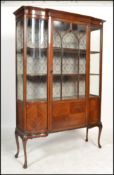 An Edwardian mahogany inlaid large inlaid serpentine fronted display cabinet. Raised on cabriole