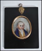 A 19th century watercolour on ivory miniature painting of a young man, set within an ebonised