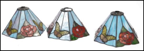 A set of three 20th century coloured stained glass leaded  light shades in the manner of Tiffany,