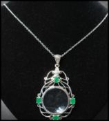 A 925 silver Art Nouveau style pendant necklace strung with an ornate magnifying glass set with