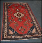 A 20th century Kelim woolen rug / carpet , on red ground with a central medallion, inner border with