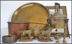 A mixed group of metal ware to include an 18th century brass charger, dog place holders / calendar