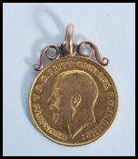 A gold 1914 George V half Sovereign with mounted scroll work gold  mount total gross weight 4.5g