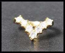 A hallmarked 18ct gold and diamond wishbone ring. The seven round cut diamonds of approx 10pnts each