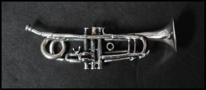 A 925 silver novelty pendant in the form of a trumpet with round bale. Marked 925.  Measures 6cms.