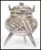 An unusual 19th century Chinese silver condiment in the form of a censer ding bowl raised on