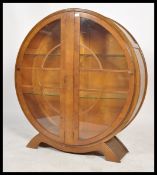 A 1930's Art Deco circular china display cabinet. The shaped plinth base with roundel display