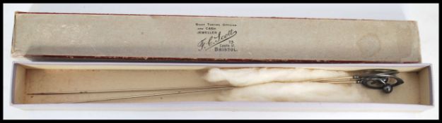 A pair of Charles Horner high Art Nouveau stick - hat pins having finial and scroll mounts set