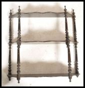A 19th century Coromandel wood etagere whatnot of shaped form with multiple shelves having barley