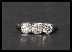 A 14ct white gold three stone diamond ring set with three diamonds in a prong setting. Diamonds