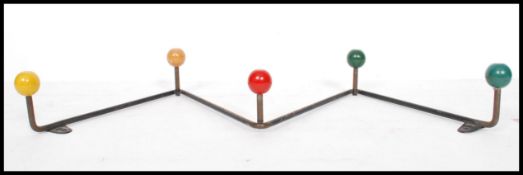 A vintage retro sputnik atomic set of coat hooks in a painted finish with multi coloured ball finial