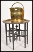 An early 20th century metamorphic brass charger table along with a 19th century Victorian coal