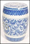 A 20th century Chinese blue and white ceramic barrel stool - stand. Barrel form with pierced top