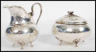 An early 20th century continental 800 silver marked lidded sugar bowl and creamer milk jug. Both