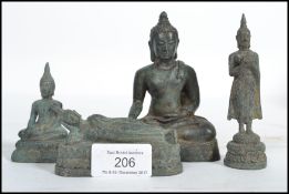 A group of four 19th century Oriental Chinese bronze Buddhas modelled in a reclined position,