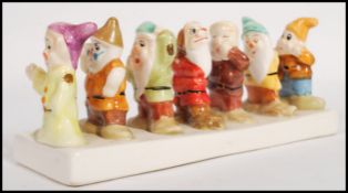 A vintage 20th century Snow White and he Seven Dwarfs ceramic toast rack. Measures 20cm long.