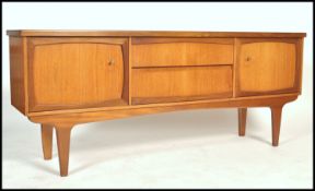 A vintage large 6ft  mid century teak wood sideboard in the Danish manner having central drawers