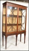 An Edwardian mahogany chippendale revival large  display cabinet. Raised on square tapered legs with