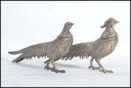 A brace pair of vintage 20th century silver plated pheasants of typical form.