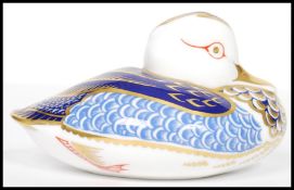 A Royal Crown Derby Teal paperweight, with red stamp to underside, silver stopper, 6cm high and 12cm